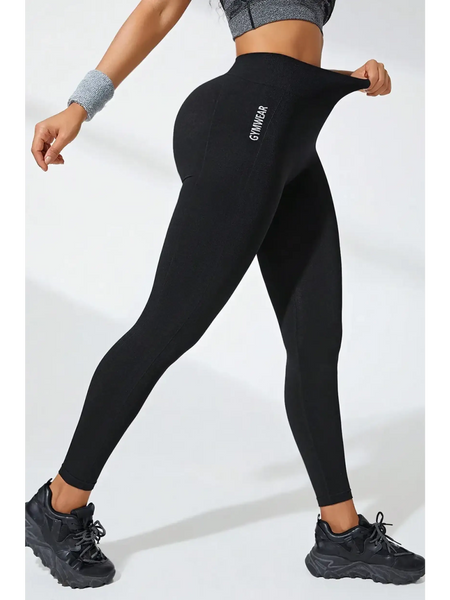 Babe Beachwear black high waisted leggings stretch fit with logo on side worn with athletic shoes