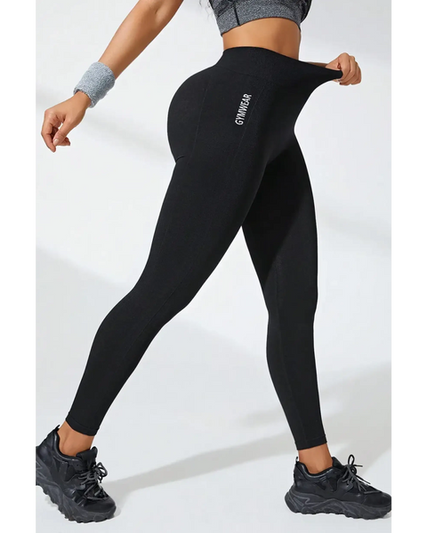 Babe Beachwear black high waisted leggings stretch fit with logo on side worn with athletic shoes