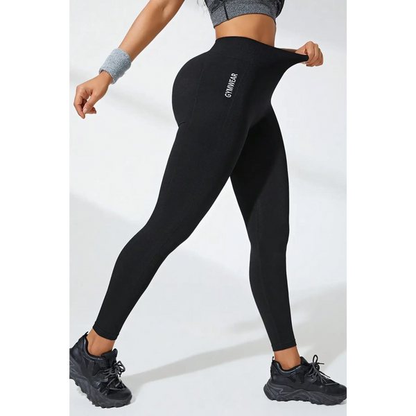 Babe Beachwear black high waisted leggings stretch fit with logo on side worn with athletic shoes