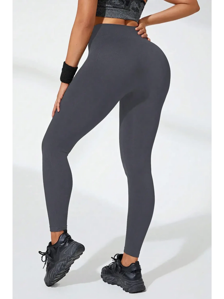 Babe Beachwear black high waisted leggings worn by model with athletic shoes and wristband