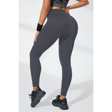 Babe Beachwear black high waisted leggings worn by model with athletic shoes and wristband