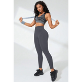 Babe Beachwaer black high waisted leggings worn by model with athletic top and black sneakers