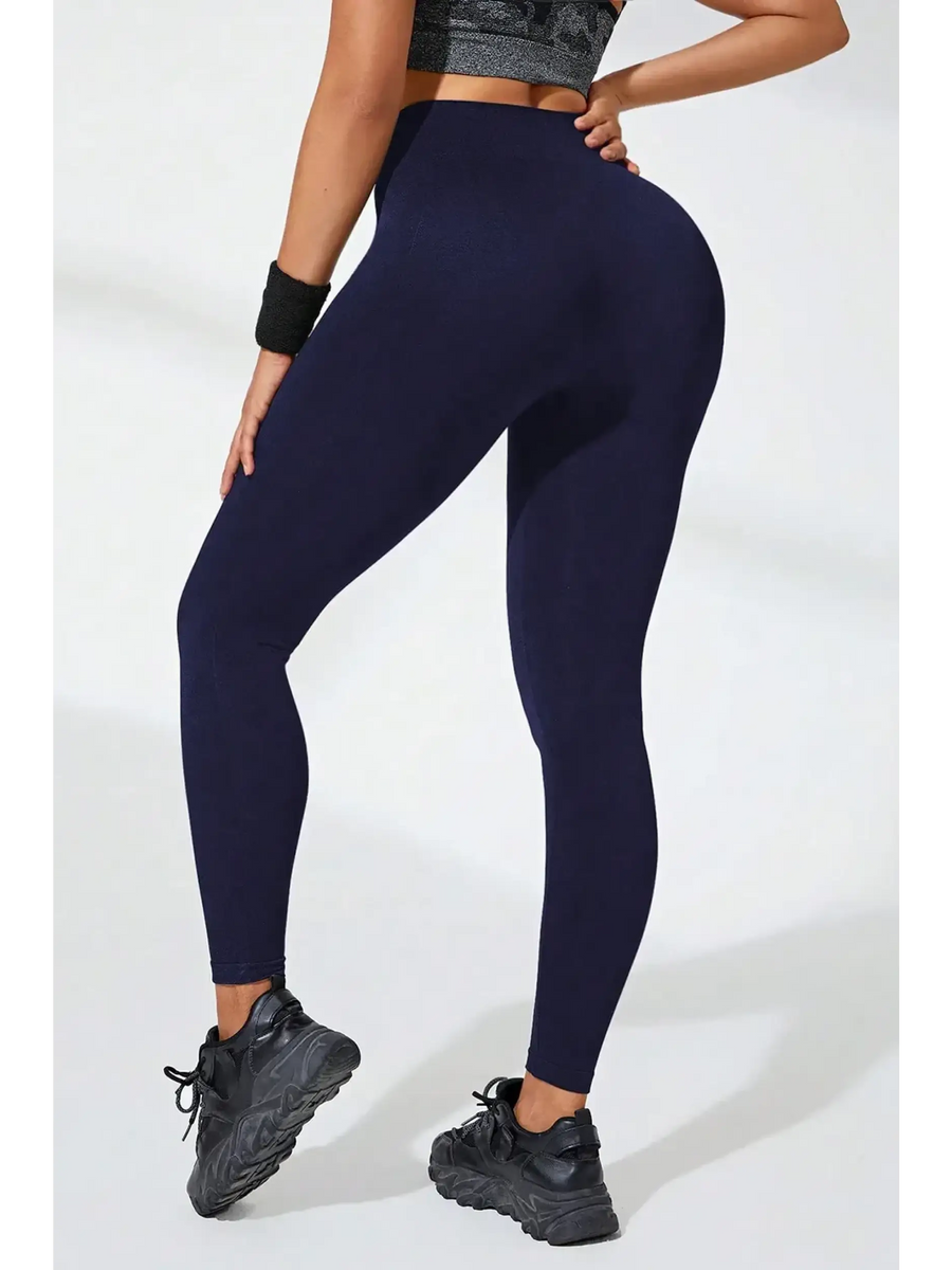 Babe Beachwear black high waisted leggings modeled from the back with a sporty look and black sneakers