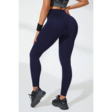 Babe Beachwear black high waisted leggings modeled from the back with a sporty look and black sneakers