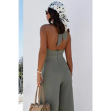 Back view of Babe Beachwaer's halter neck wide leg jumpsuit in olive green with open back and high waist
