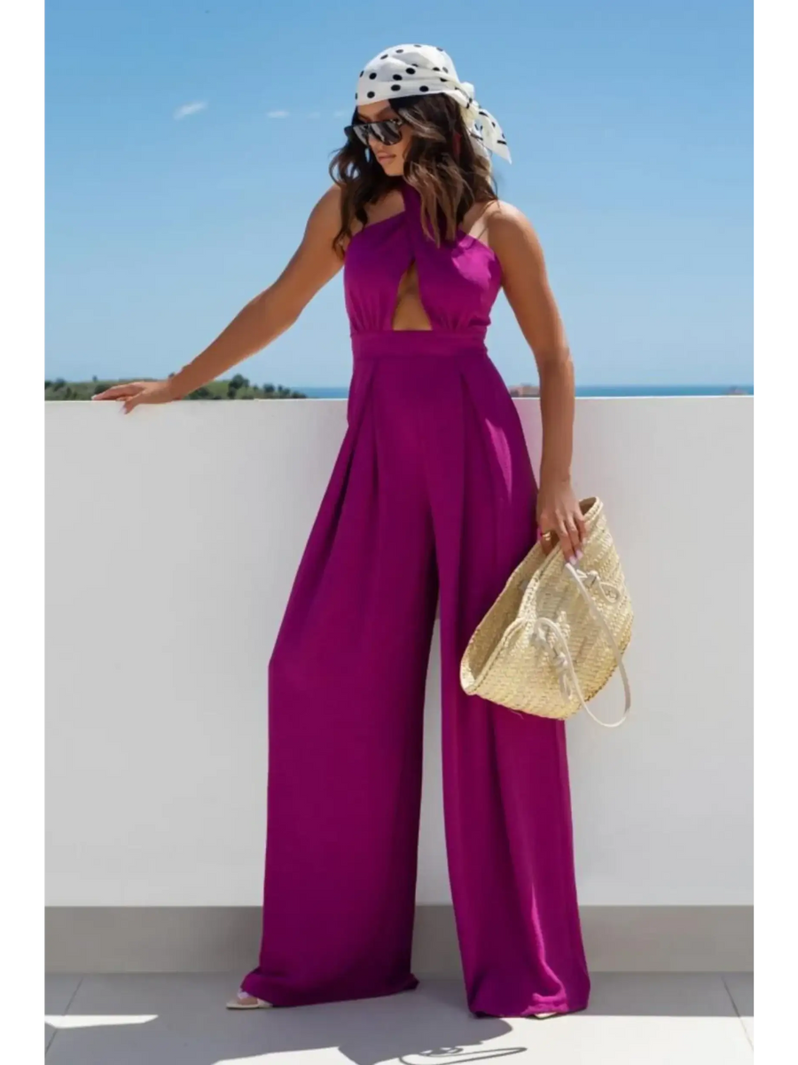 Babe Beachwear halter neck wide leg jumpsuit in bright purple worn with a scarf and sunglasses
