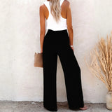 Babe Beachwaer high waisted beach pants set in black wide-leg style worn with white sleeveless top