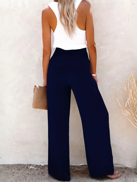 Babe Beachwaer high waisted beach pants set in navy blue worn with white sleeveless top