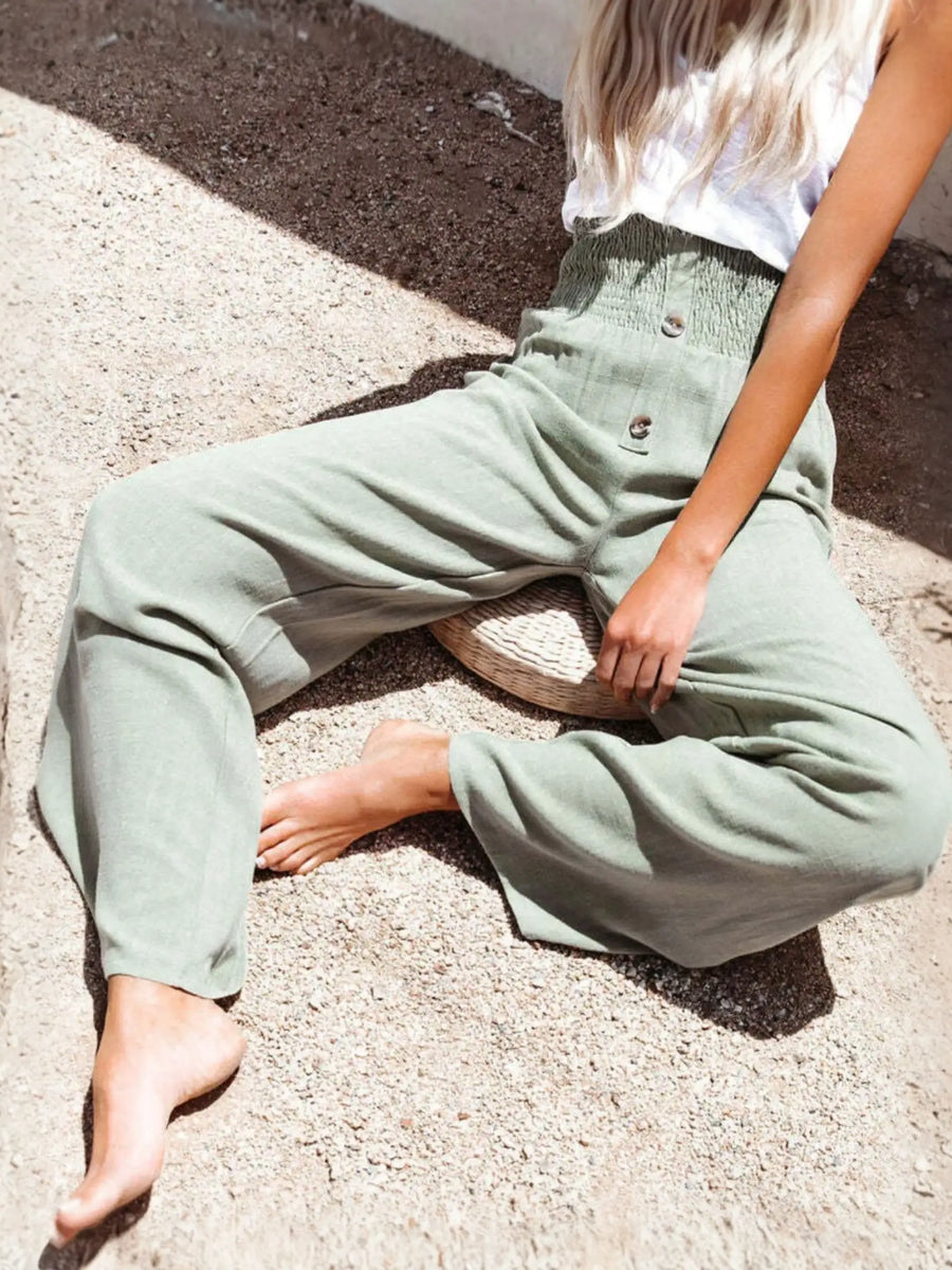 Babe Beachwear high waisted beach pants set in light green worn by a seated woman outdoors