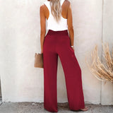 Babe Beachwaer high waisted beach pants set in red with wide legs worn by woman with white tank top