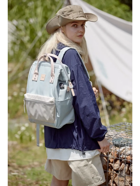 Woman wearing Himawari - Best Backpack by Babe Beachwaer in light blue outdoors with hiking gear