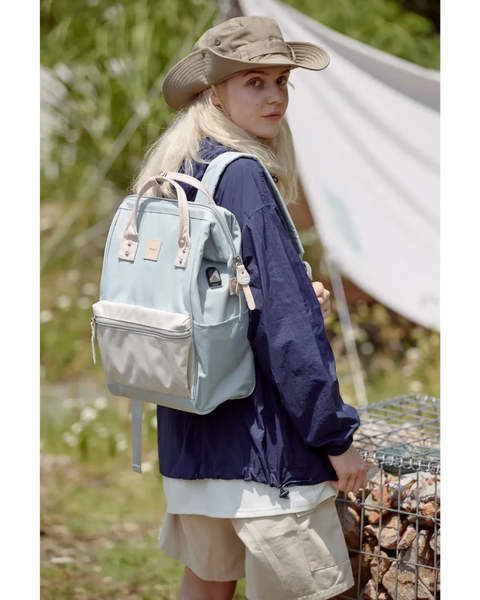 Woman wearing Himawari - Best Backpack by Babe Beachwaer in light blue outdoors with hiking gear