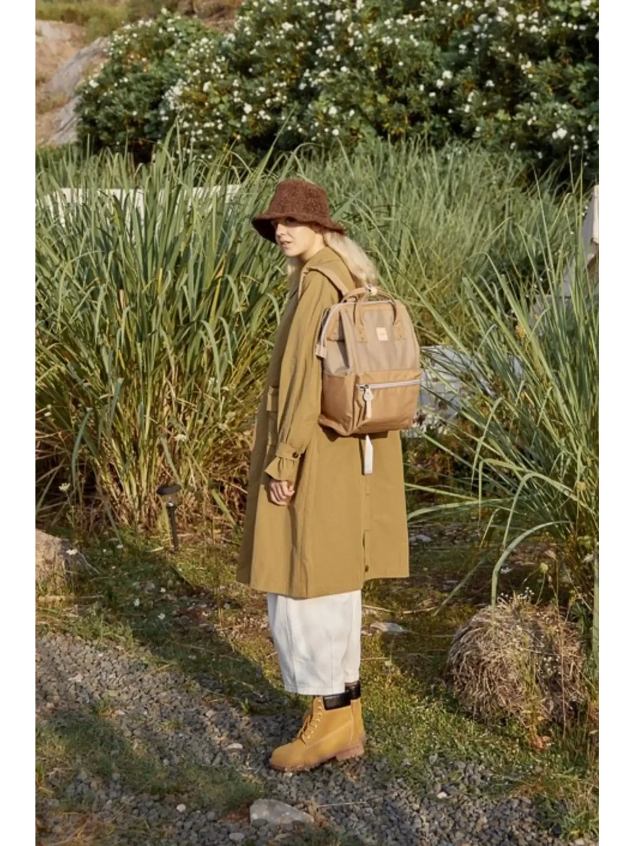 Woman wearing light brown Himawari - Best Backpack by Babe Beachwaer in outdoor nature setting