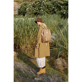 Woman wearing light brown Himawari - Best Backpack by Babe Beachwaer in outdoor nature setting