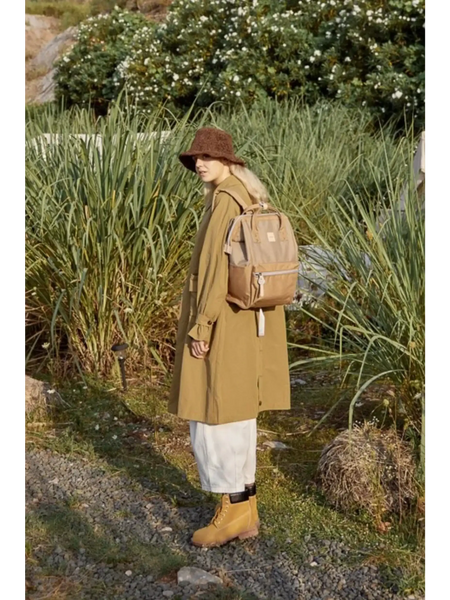 Woman wearing light brown Himawari - Best Backpack by Babe Beachwaer in outdoor nature setting