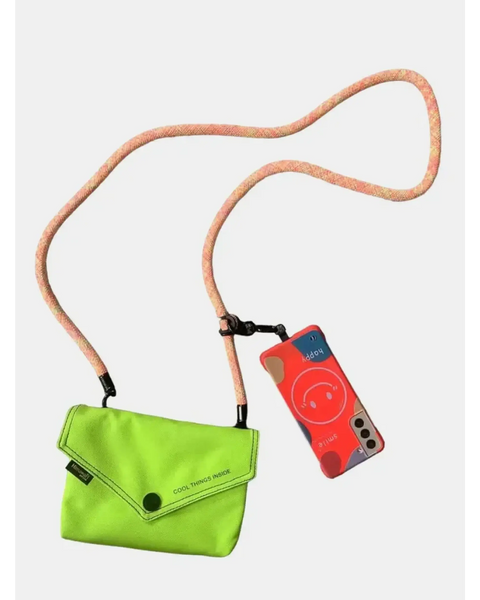 Babe Beachwaer Himawari Crossbody Phone Wallet in bright green with long strap holding a phone