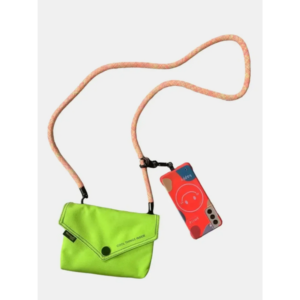 Babe Beachwaer Himawari Crossbody Phone Wallet in bright green with long strap holding a phone