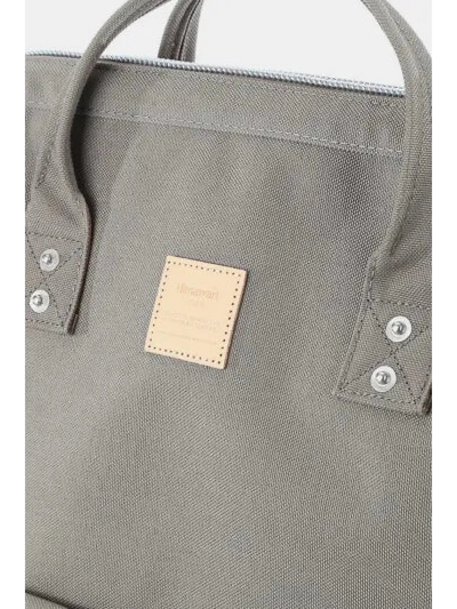 Close-up of Babe Beachwear himawari durable backpack in gray with stitched handles and logo patch