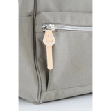 Close-up of gray himawari durable backpack with silver zipper and beige leather pull tab