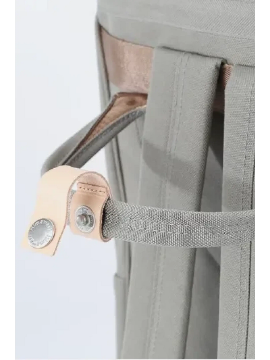 Close-up of himawari durable backpack strap and buckle detail in gray with beige leather accents