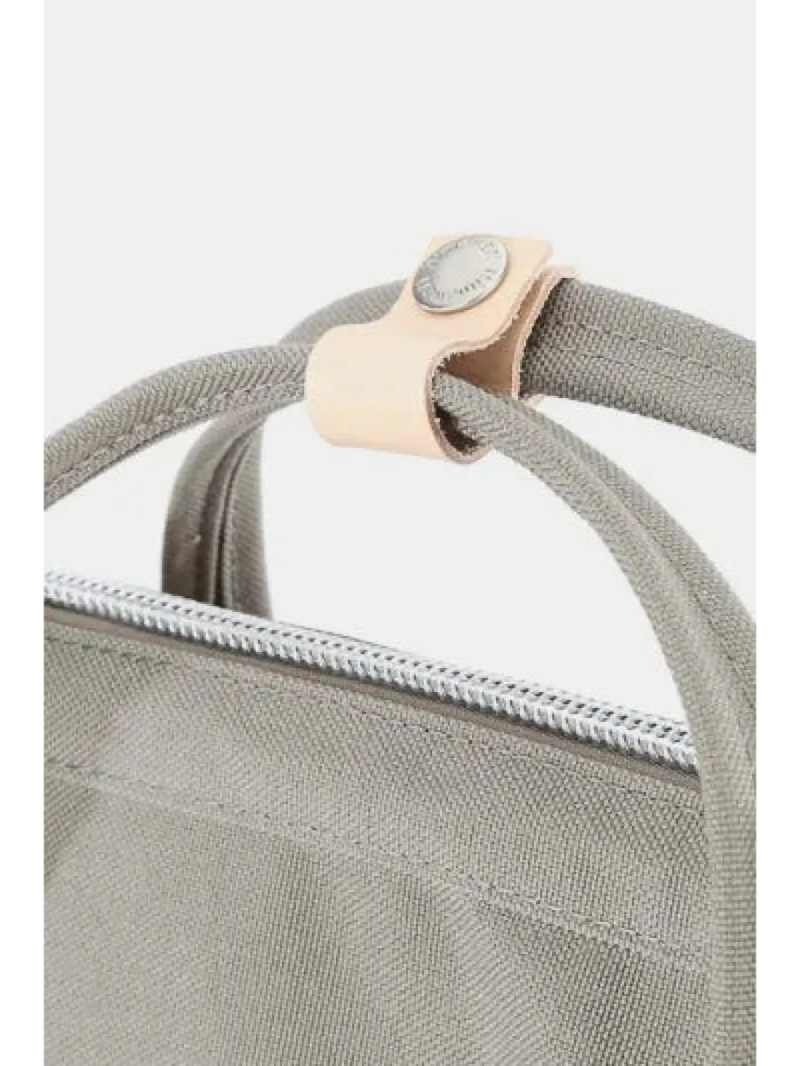 Close-up of Babe Beachwear himawari durable backpack handle and zipper in gray fabric