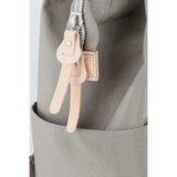 Close-up of zipper and leather pull tabs on Babe Beachwear himawari durable backpack in gray fabric