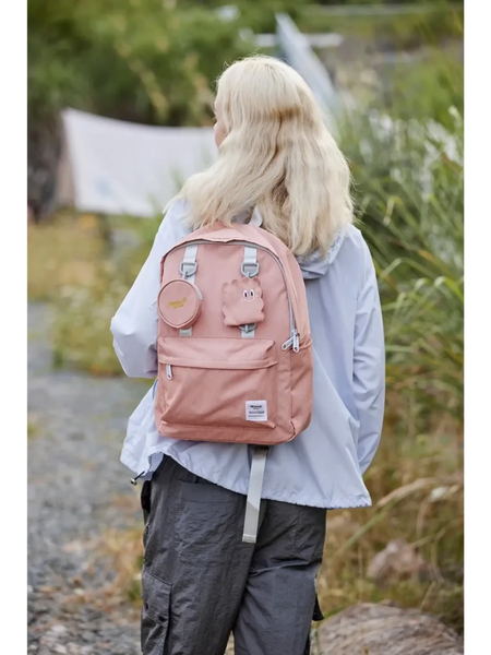 Medium beach backpack for school or travel by Babe Beachwear in pink worn by person outdoors