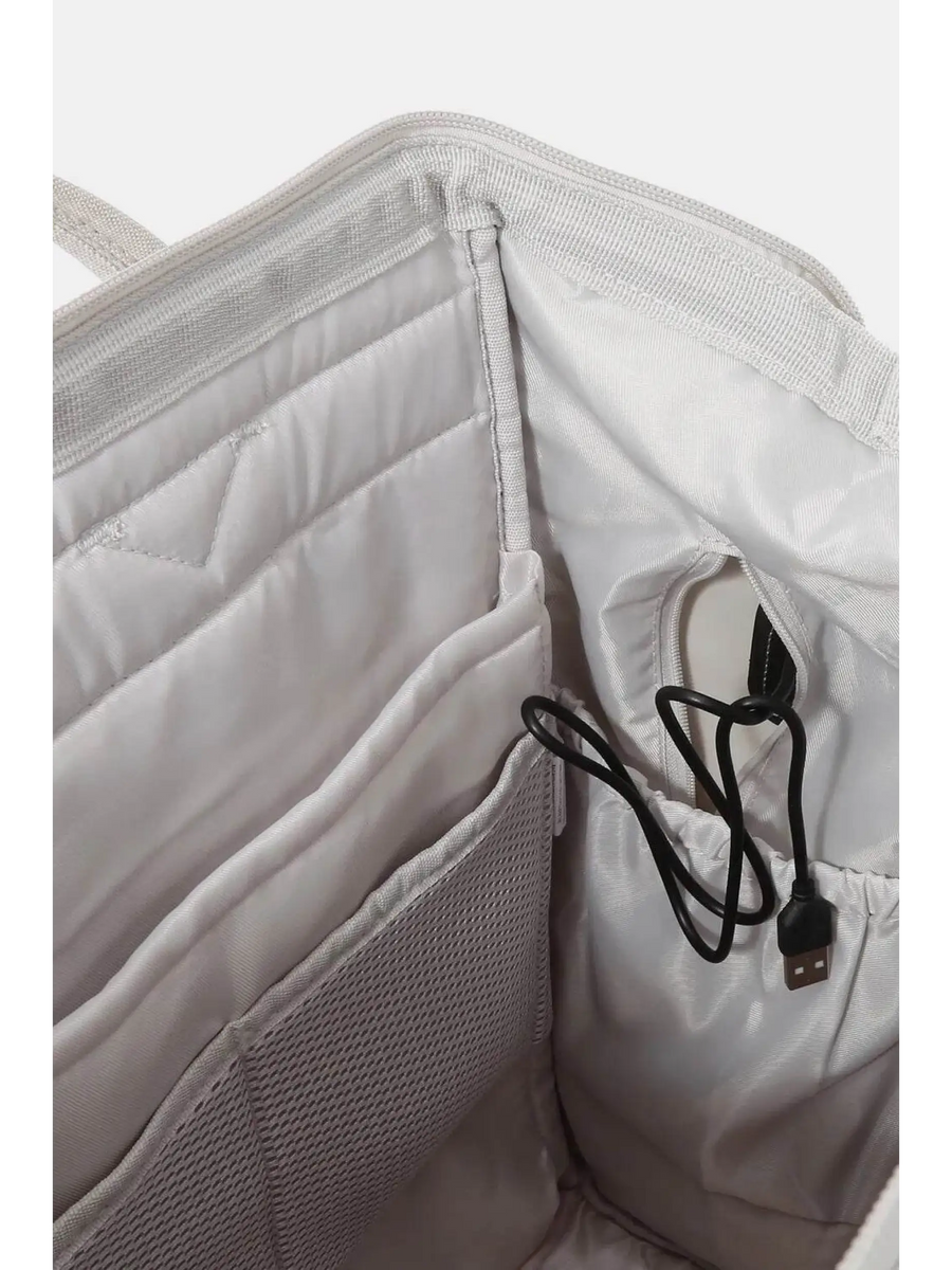 Interior view of Himawari stylish summer backpack for women showing padded compartments and USB charging port cable