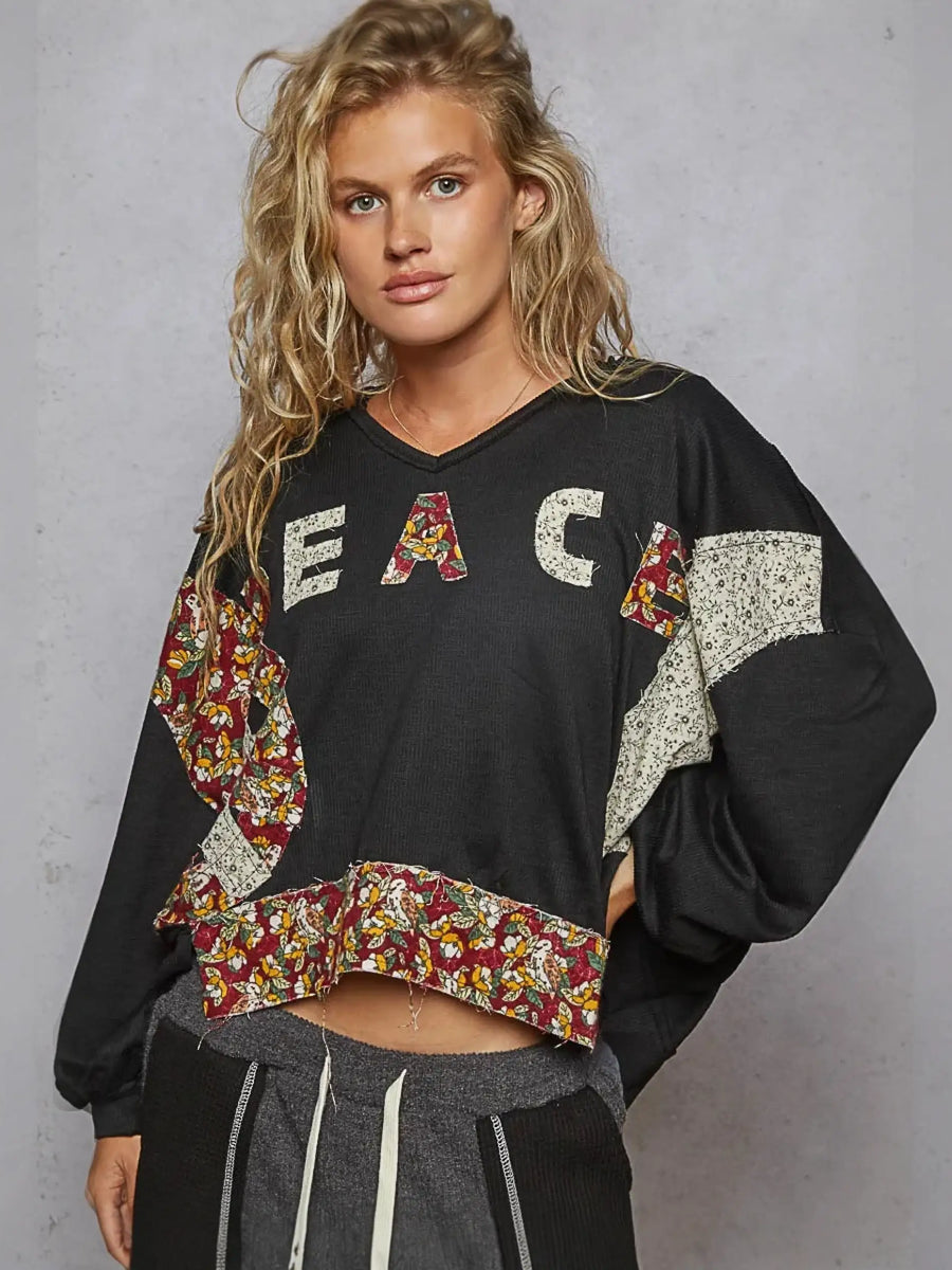 Black cropped sweatshirt with floral patches from Rock the Bloom collection