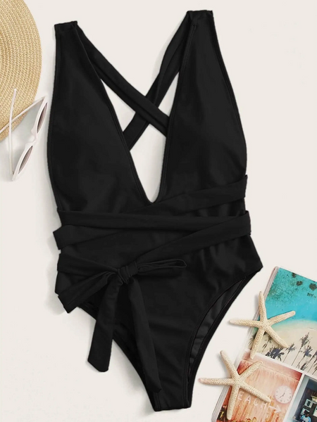 Trendsi black swimsuit with cross back and waist tie alongside sunglasses straw hat and starfish with beach book