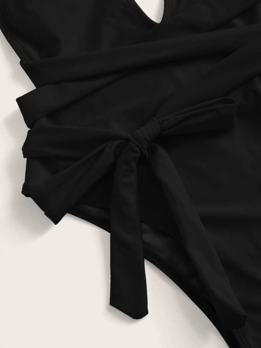 Trendsi black swimsuit close up showing side tie detail for Hot Pink halter one piece