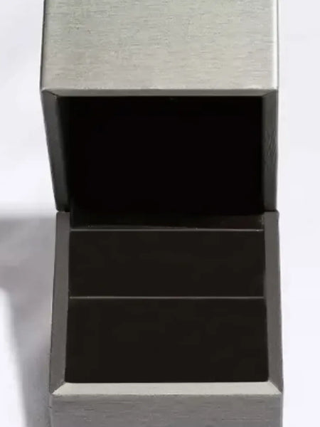 Empty gray ring box with black velvet interior for displaying an infinity Moissanite band ring