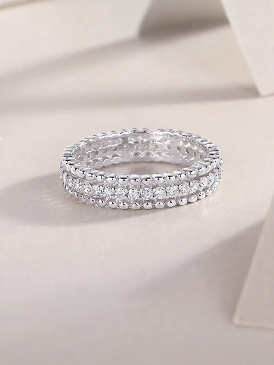 Babe Beachwear infinity Moissanite band ring with sparkling round-cut stones in silver setting