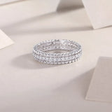 Babe Beachwear infinity Moissanite band ring with sparkling round-cut stones in silver setting