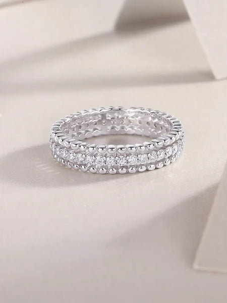 Babe Beachwear infinity Moissanite band ring with sparkling round-cut stones in silver setting