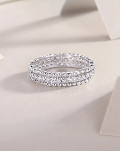 Babe Beachwear infinity Moissanite band ring with sparkling round-cut stones in silver setting