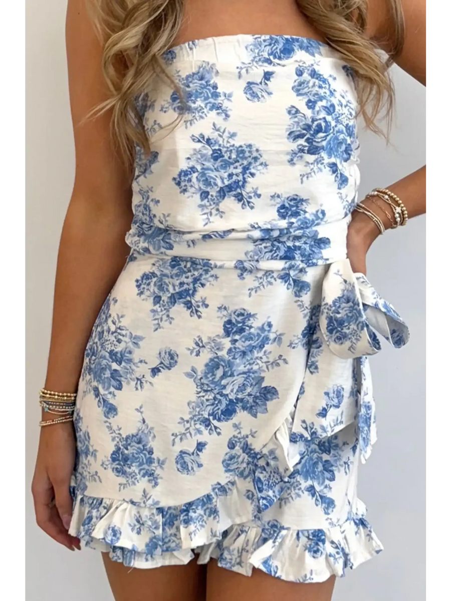 Junior size strapless ruffle hem romper with blue floral print and side bow from Trendsi