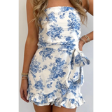 Junior size strapless ruffle hem romper with blue floral print and side bow from Trendsi
