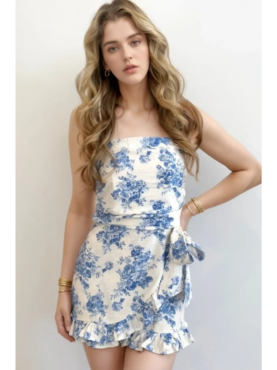 Trendsi junior size strapless ruffle hem romper in white with blue floral print and side bow tie