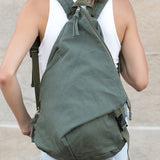 Babe Beachwaer Kai Asymetric Canvas Backpack in green worn by person with white tank top and jeans