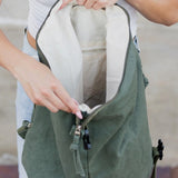Open green Kai Asymetric Canvas Backpack by Babe Beachwaer showing spacious interior and zipper pocket
