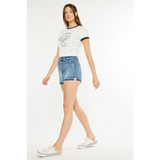 Woman wearing kancan button fly cutoff shorts in blue denim with white casual shoes and white graphic t shirt