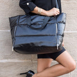 Babe Beachwear large lightweight puffer weekends black bag worn by woman with high heels
