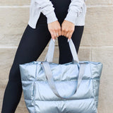 Babe Beachwaer large lightweight puffer weekends silver bag held by woman in casual outfit