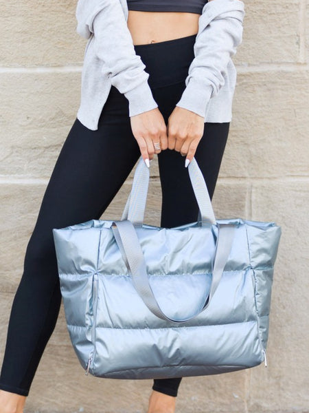 Babe Beachwaer large lightweight puffer weekends silver bag held by woman in casual outfit
