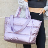 Babe Beachwaer large lightweight puffer weekends bag in shiny lavender held by woman in black outfit