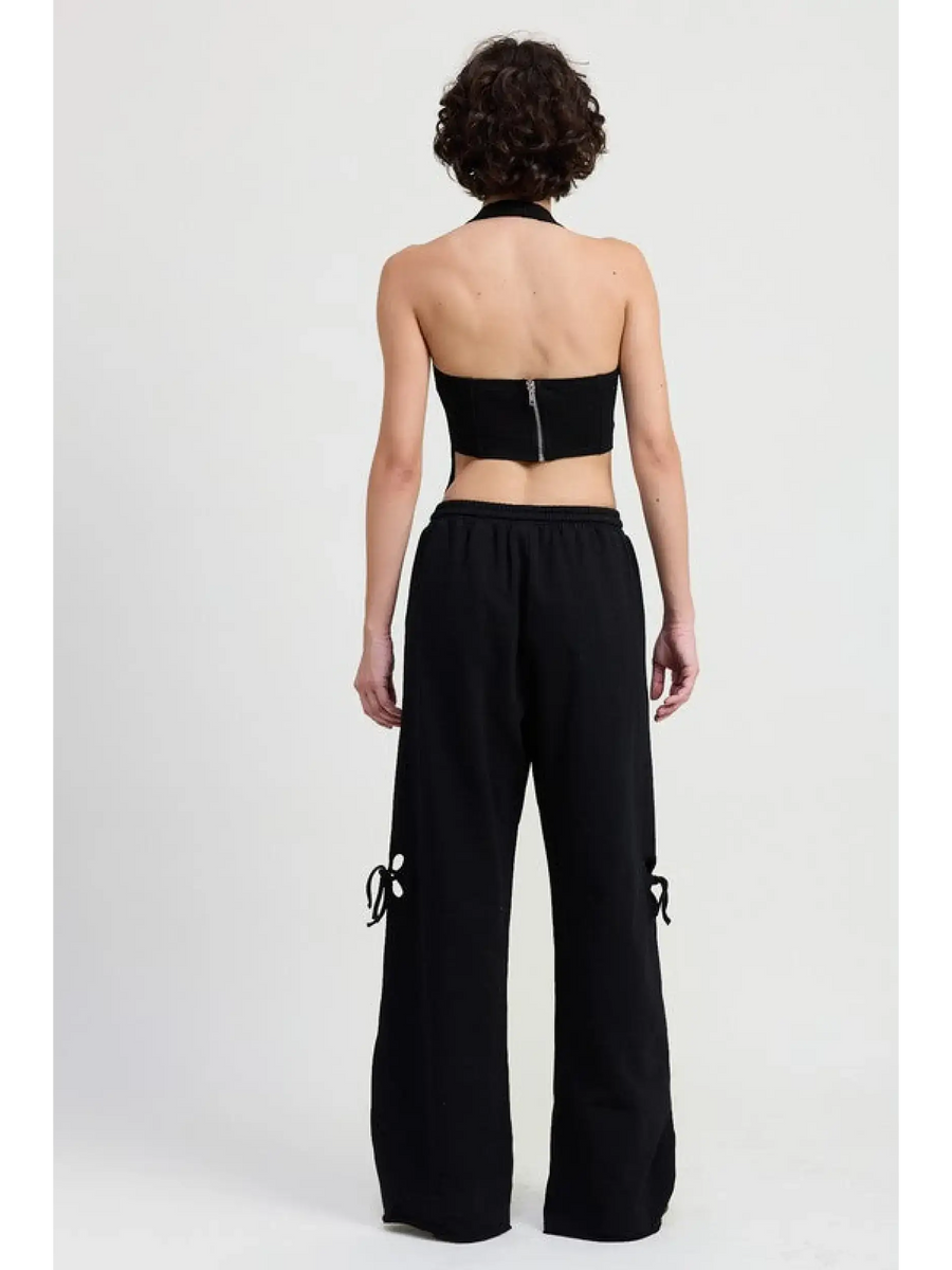 Emory Park wide leg laser cutout cotton beach pants in black worn by model from back