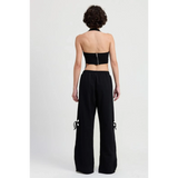 Emory Park wide leg laser cutout cotton beach pants in black worn by model from back