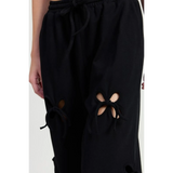 Emory Park wide leg pants featuring black laser cutout cotton beach pants with tied details at the knees