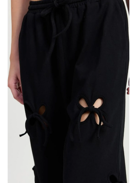 Emory Park wide leg pants featuring black laser cutout cotton beach pants with tied details at the knees